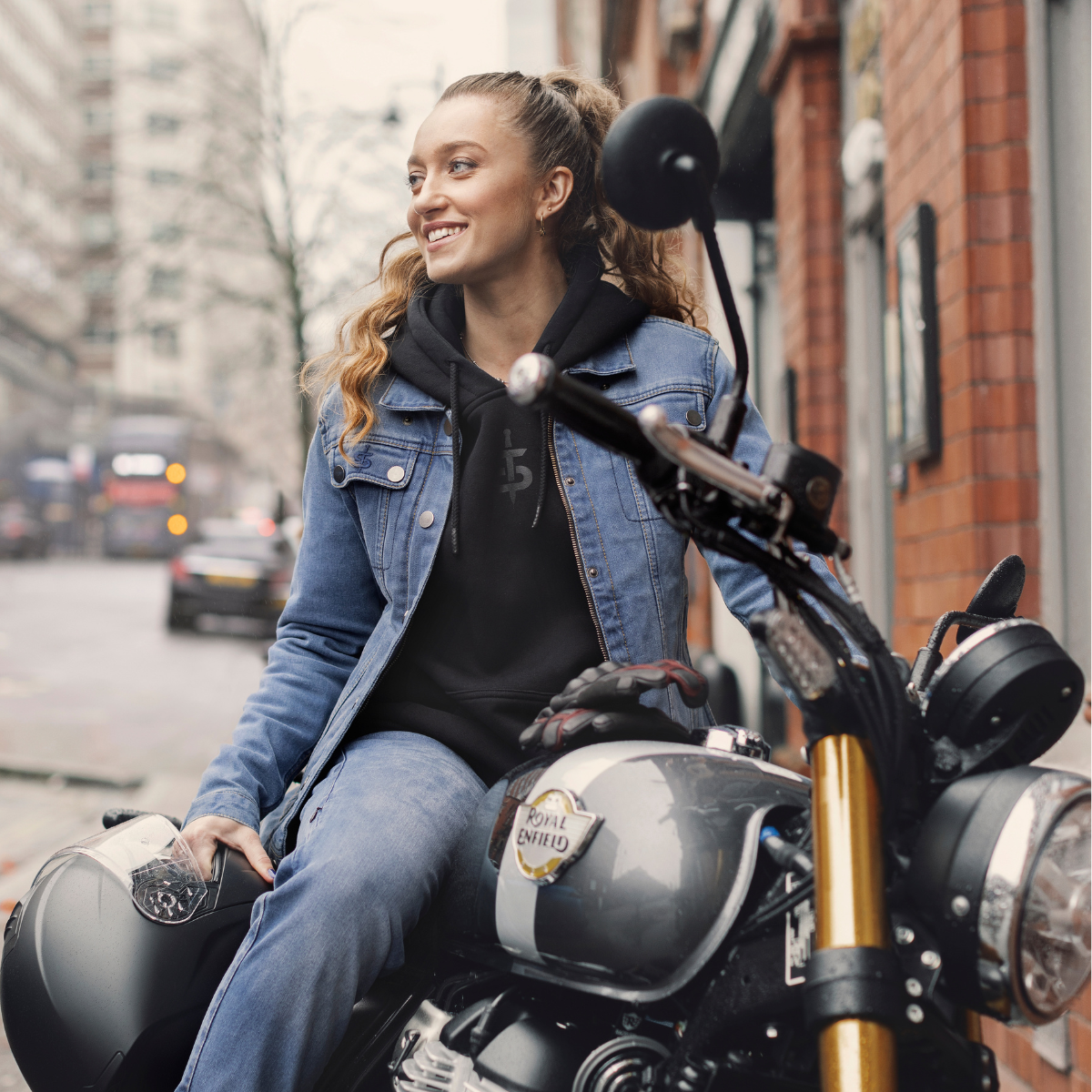 Grace Webb riding a motorbike wearing a ladies denim motorcycle jacket