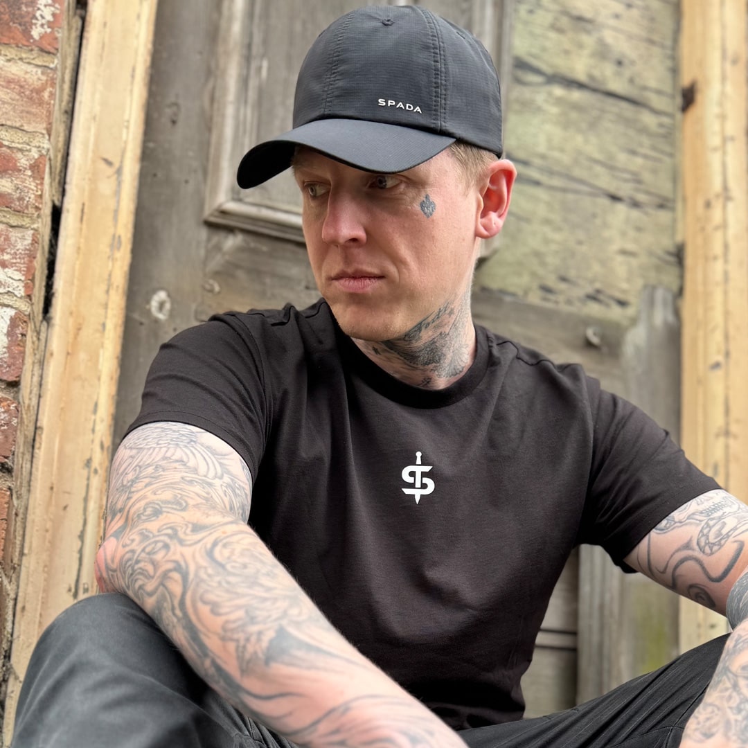 biker wearing black spada t-shirt with black spada baseball cap