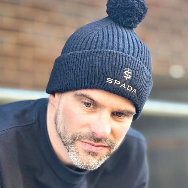 man wearing black bobble beanie hat for men