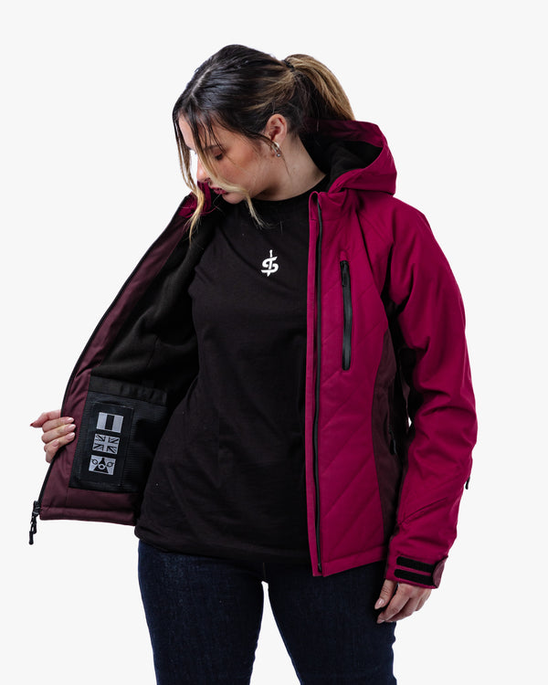 Woman wearing a red and black motorcycle jacket for women with a white logo on a white background