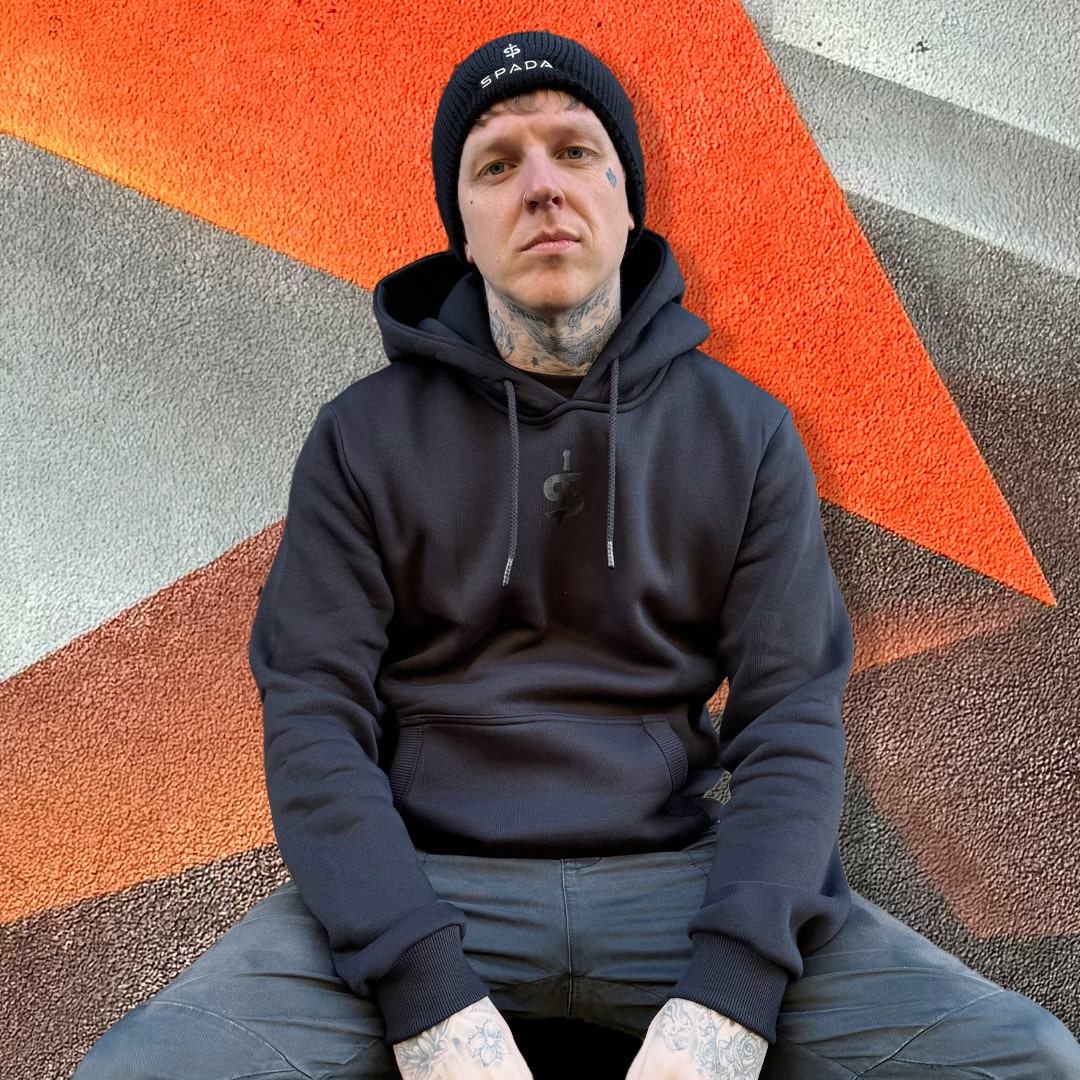 biker wearing black spada hoodie with black spada beanie