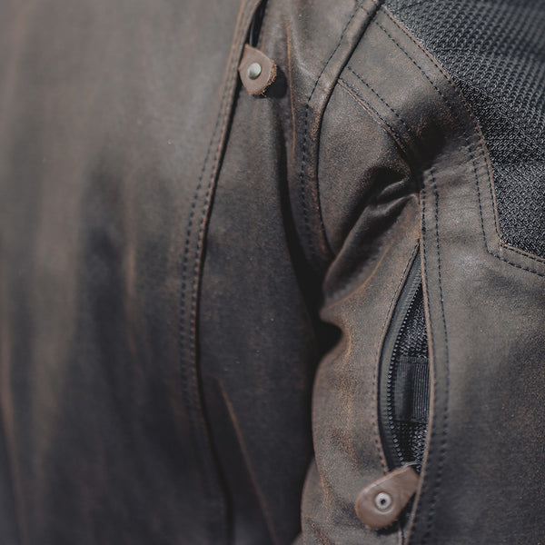 Close-up of zipper on arm pocket, showcasing durable waterproof construction and easy access