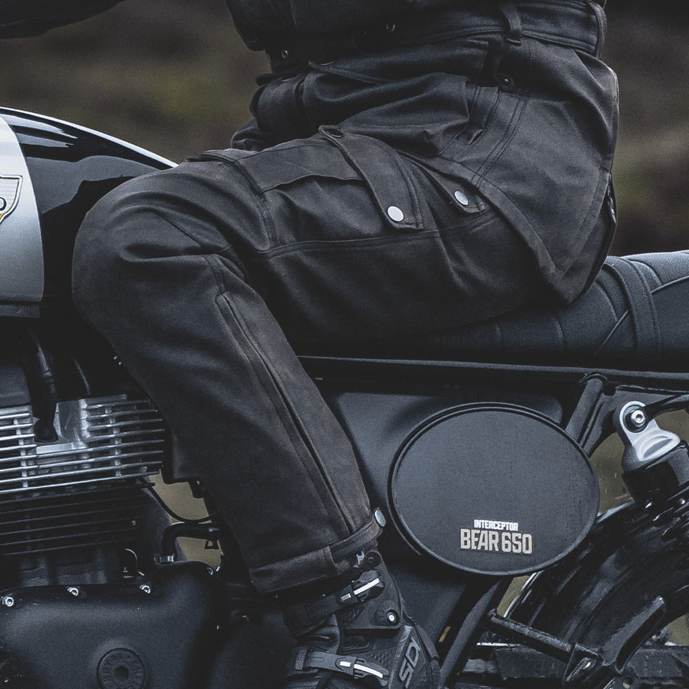biker riding motorbike wearing brown motorcycle trousers