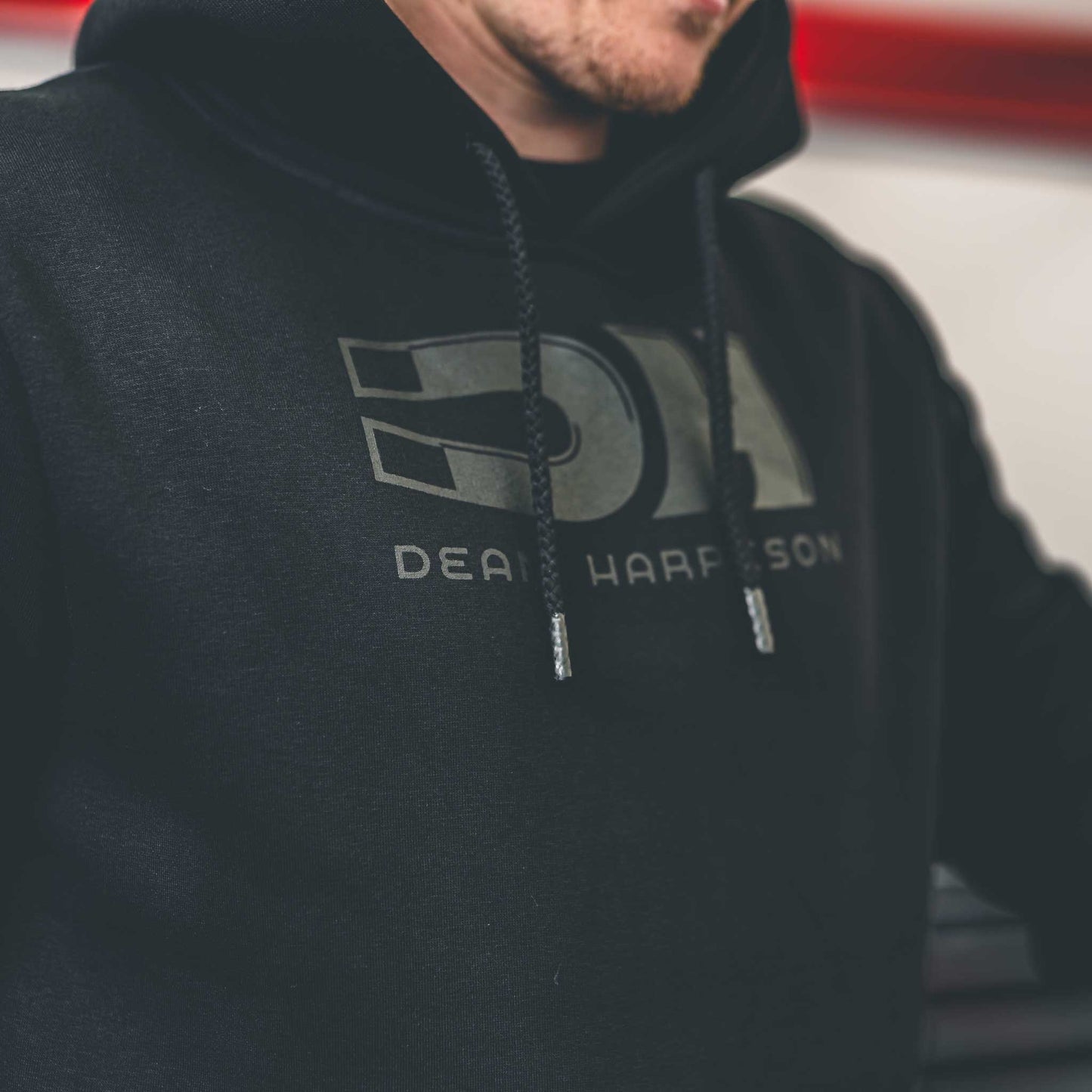 closeup of DH and dean harrison logo on dean harrison merch hoodie