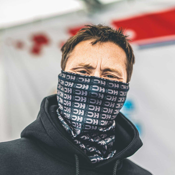 dean harrison wearing a dark neck gaiter with a pattern of his logo