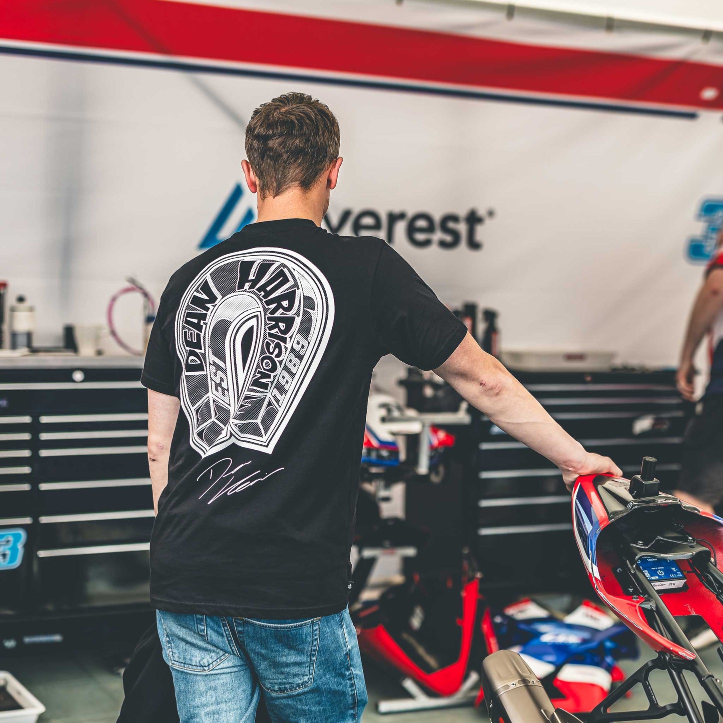 back of dean harrison wearing the dean harrison merch t-shirt with white magnet logo design