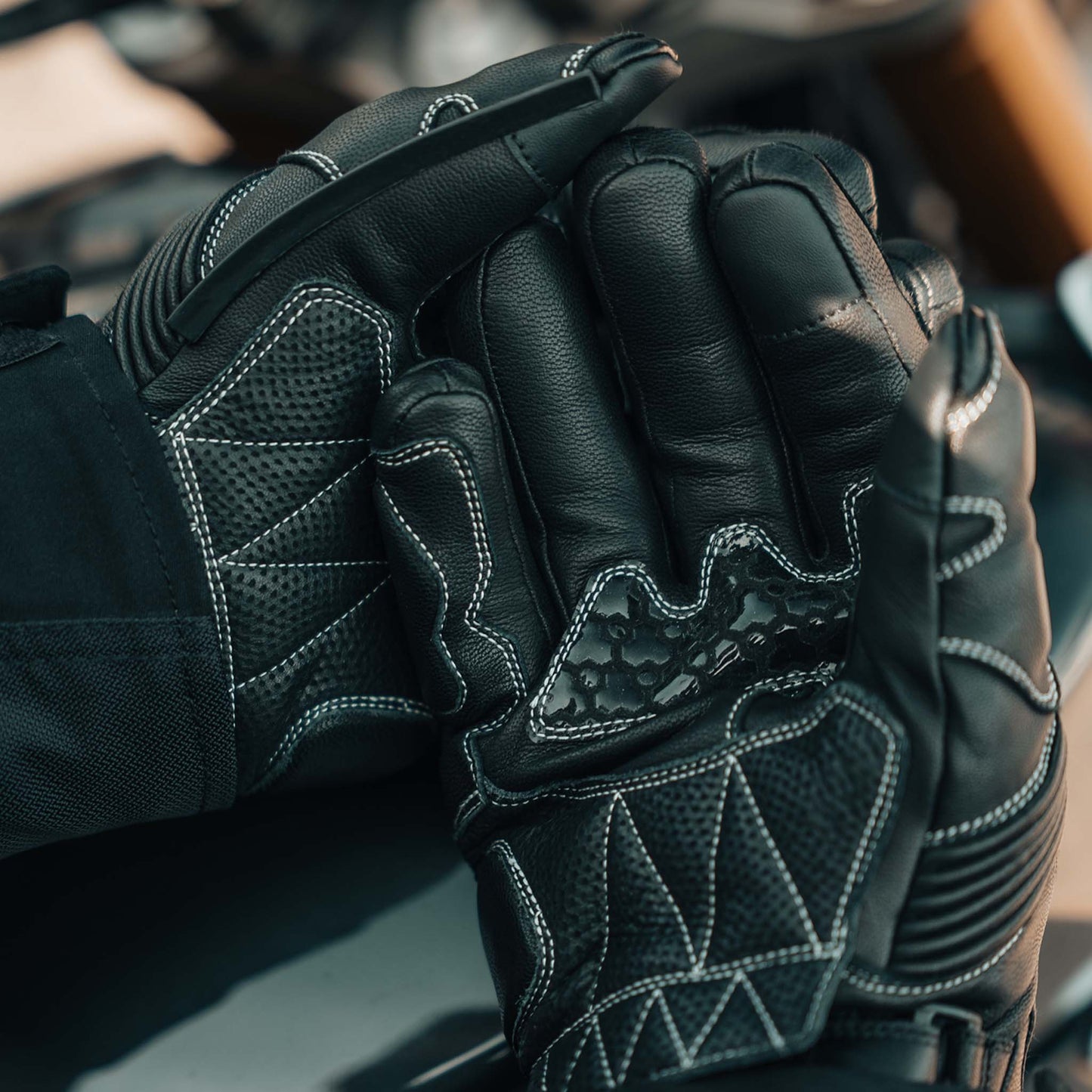 Close-up of Enforcer 2 motorcycle gloves with textured silicone palm and stitching details.