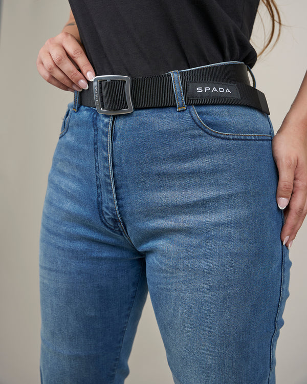 woman wearing blue biker jeans with black belt