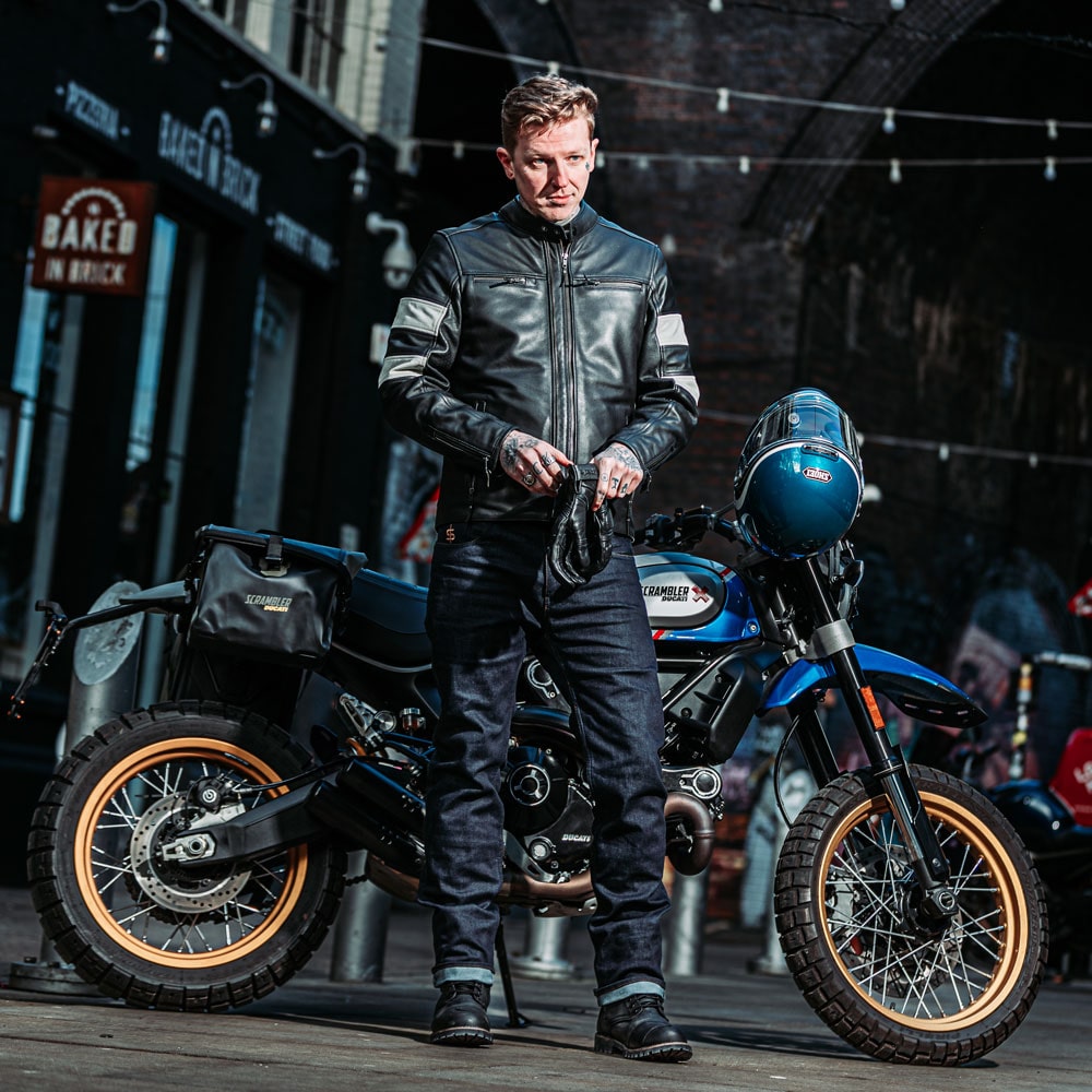 Male biker in Hanzo leather jacket putting on gloves – ready for the road in full leather riding gear