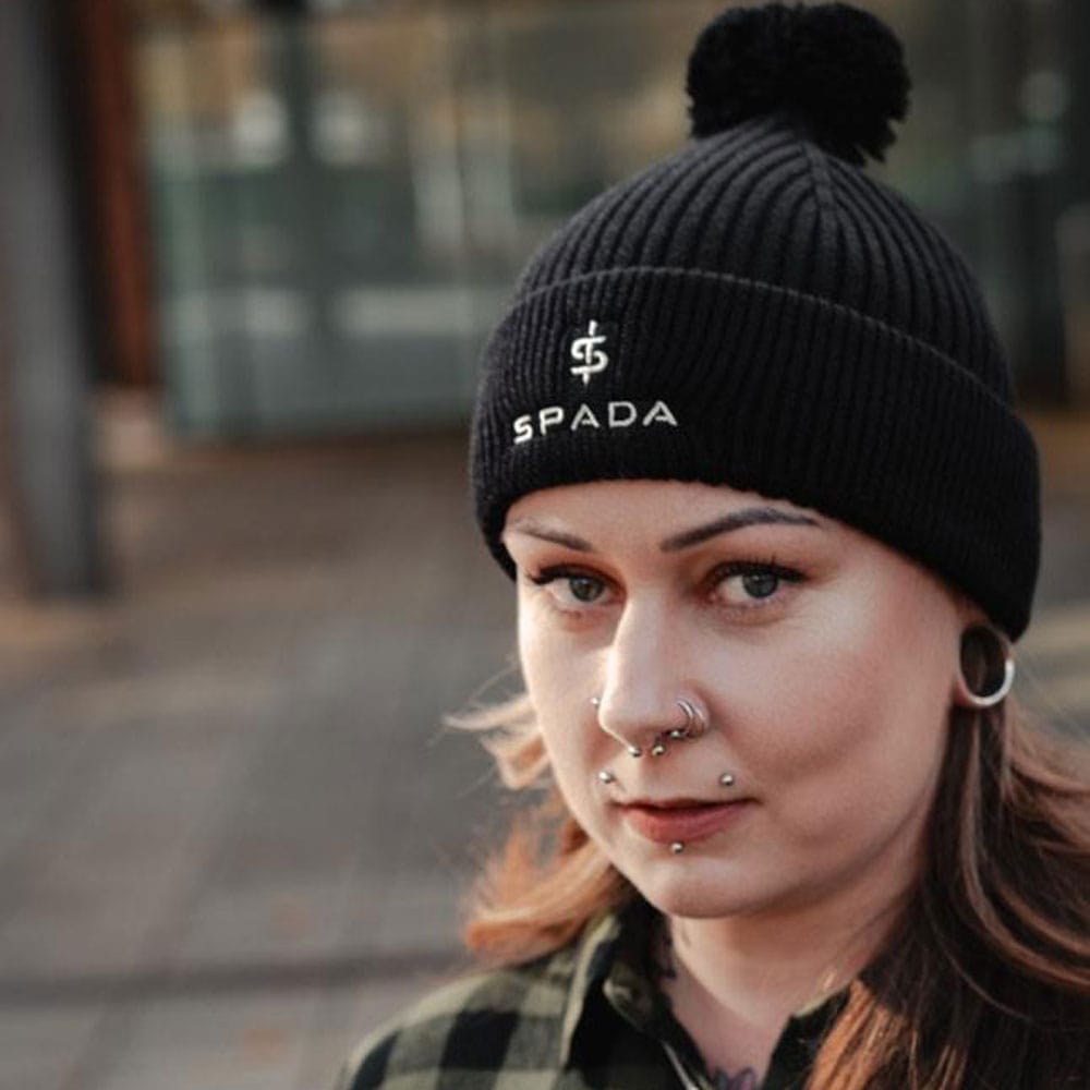 female biker wearing black thermal warm bobble beanie hat