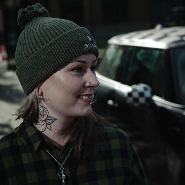 female biker wearing olive green warm bobble beanie