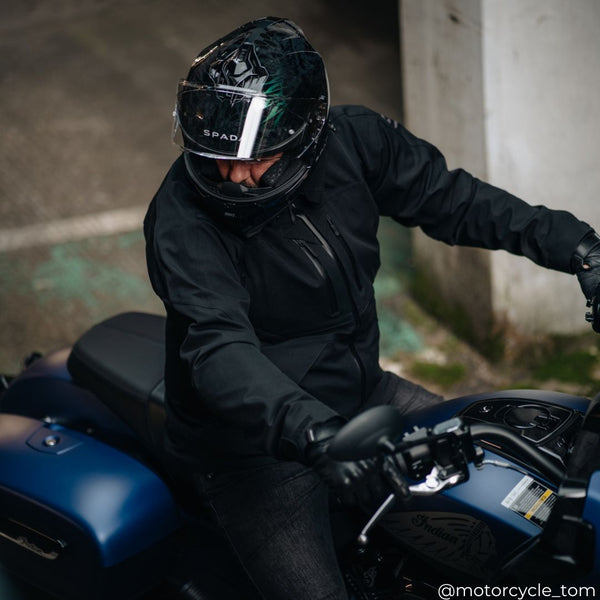 biker riding motorcycle wearing black hooded motorcycle jacket with Spada sp18 dark chameleon helmet