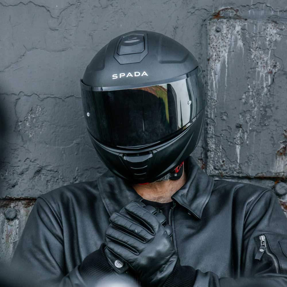 biker in all black biker gear including black motorbike helmet for men