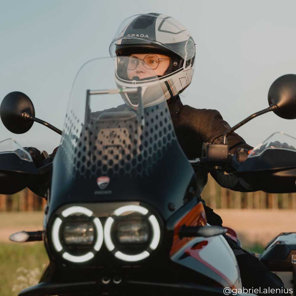 biker girl wearing white and grey flip up motorbike helmet on a ride