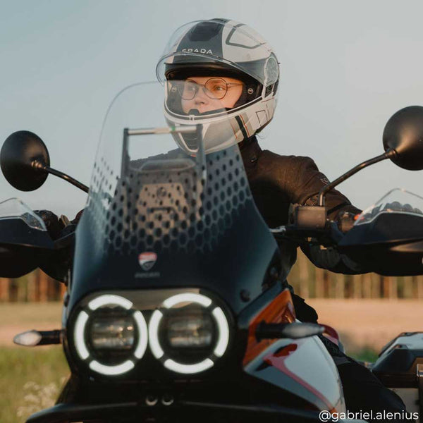 biker girl wearing white and grey flip up motorbike helmet on a ride
