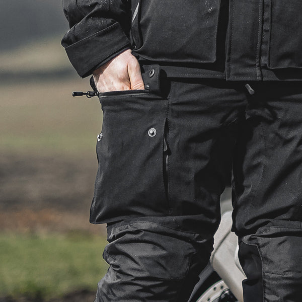 closeup of large storage side pockets on black motorcycle trousers for men