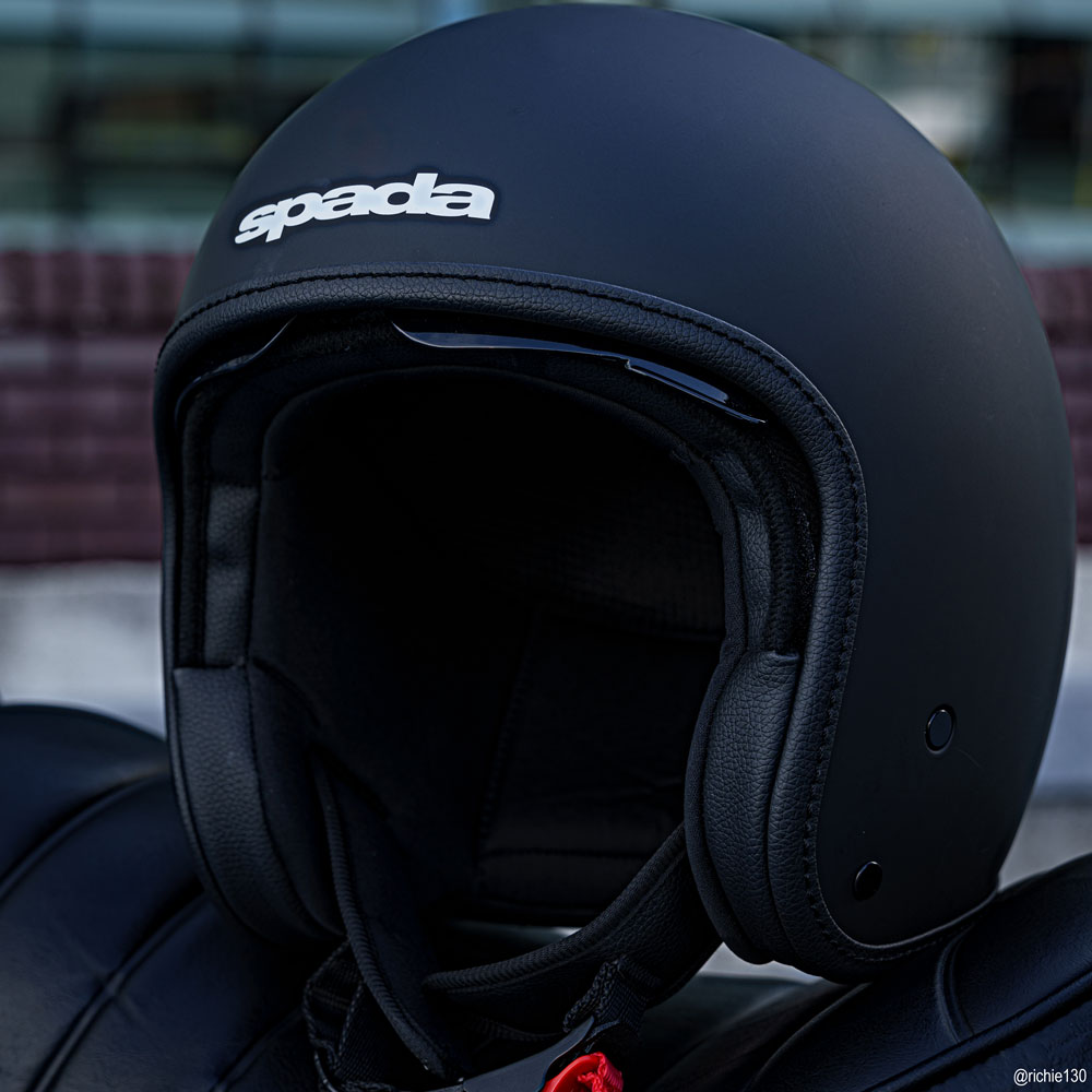 matte black open face motorbike helmet sitting on a motorbike