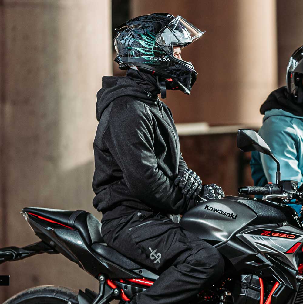 Biker wearing Blade Black hoodie seated on a motorbike with helmet – full protective gear with stealth style