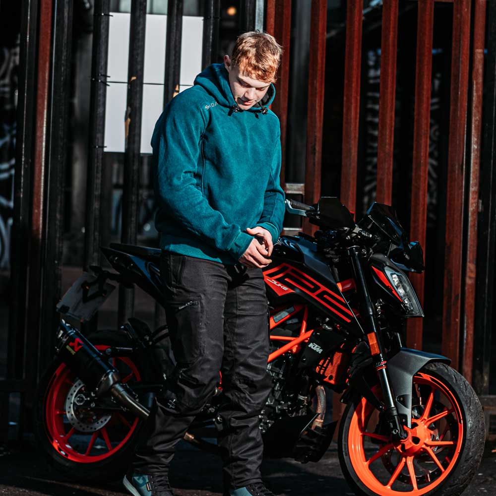 Male rider in Blade Blue unisex motorcycle hoodie with no helmet – rugged, casual gear built for riding and everyday wear