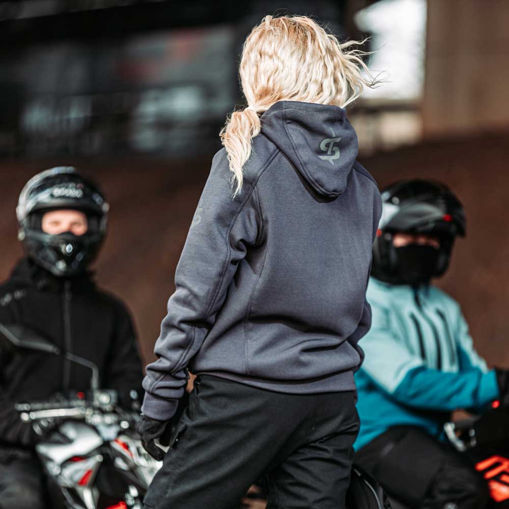 back of female biker wearing grey motorcycle hoodie for women with spada logo hoodie