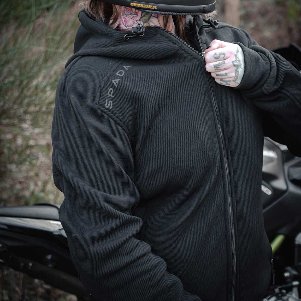 Female biker zipping up Blade Black motorcycle hoodie – armoured fit for women with practical front closure