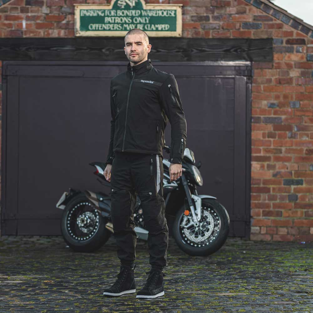 biker wearing full black motorbike gear with motorbike