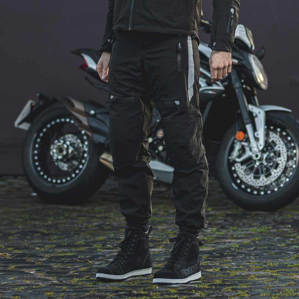 biker wearing waterproof motorcycle trousers and black motorcycle boots