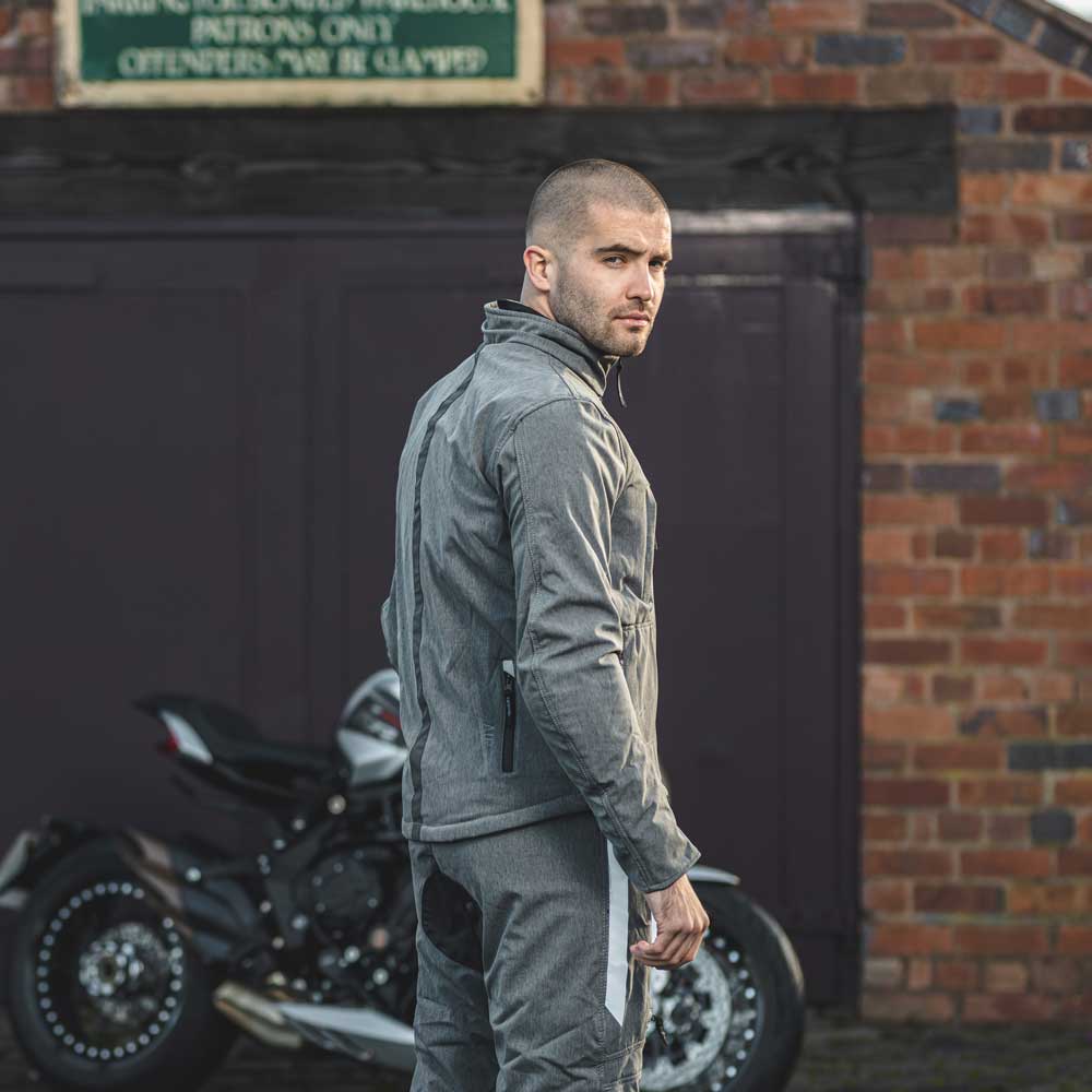 biker wearing grey motorcycle clothing with black and reflective details