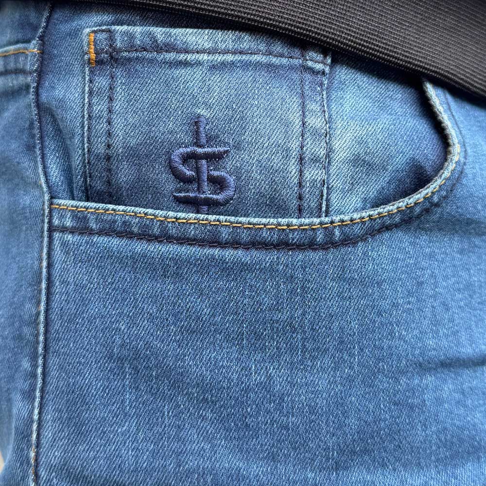 closeup of pocket with spada embroidery on blue denim jeans