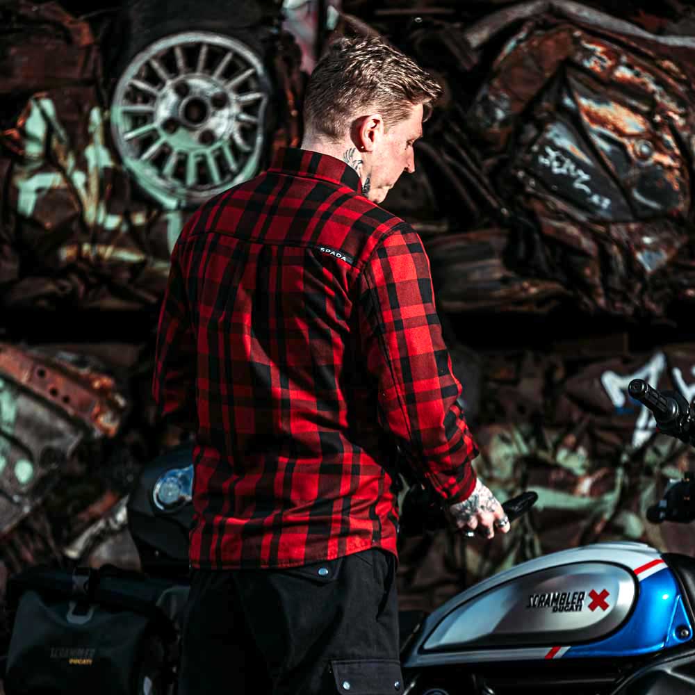 back of biker wearing a classic black and red chequered protective motorbike shirt
