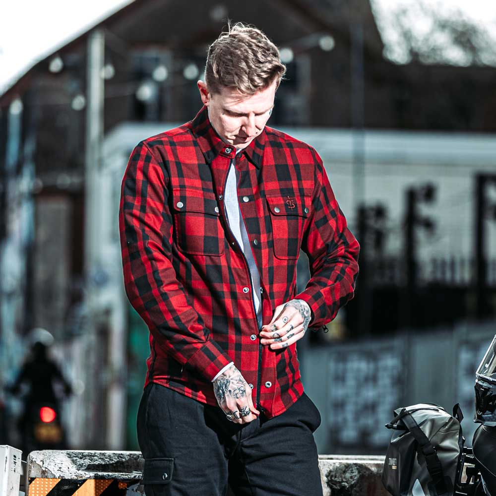biker zipping up red and black motorcycle shirt