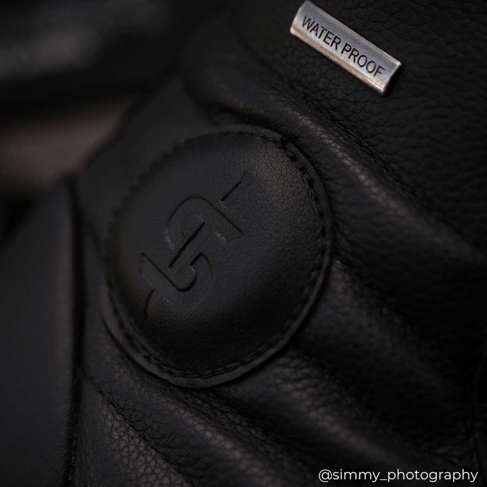 close up of ankle protector on black motorcycle trainers for men