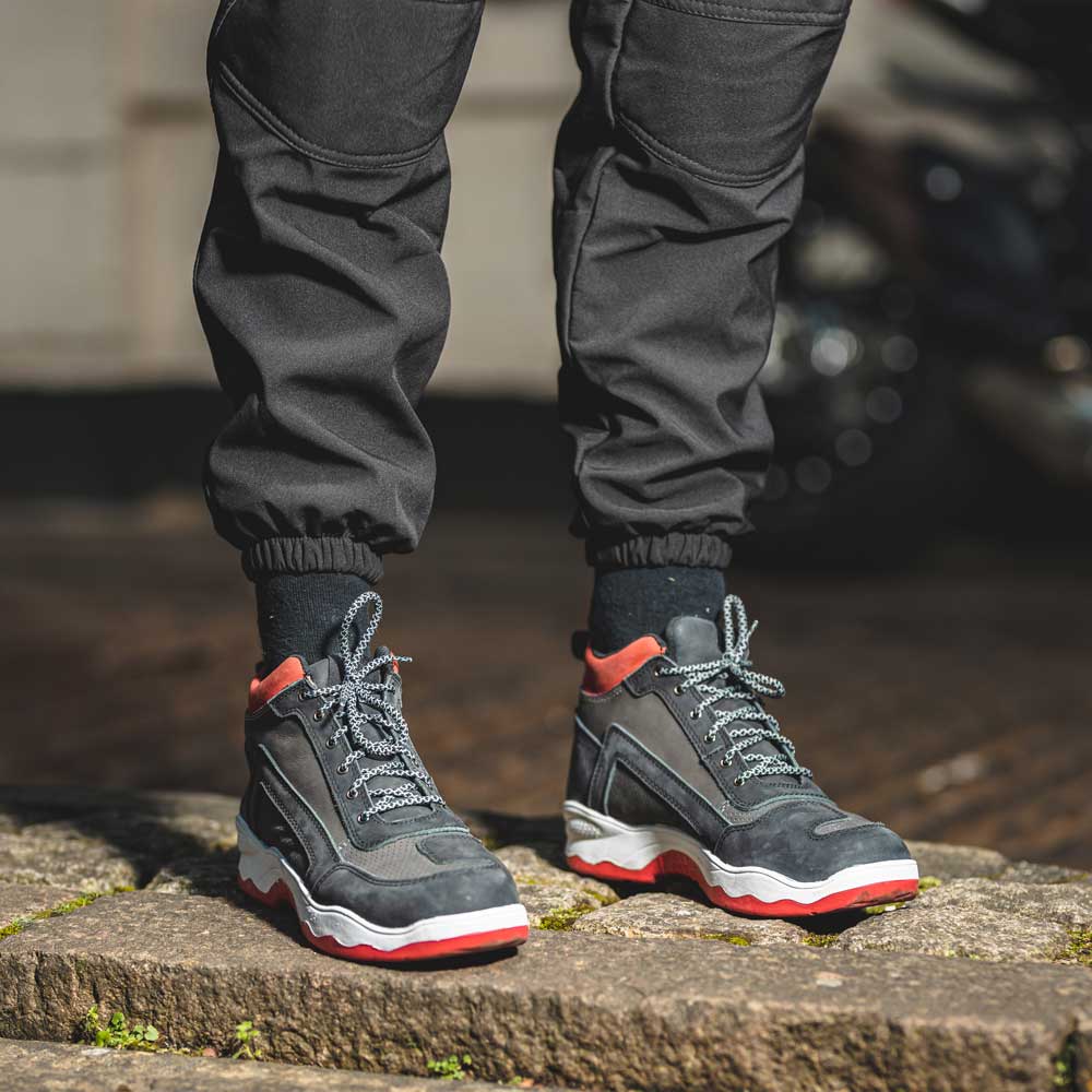 biker wearing black and red motorcycle trainers
