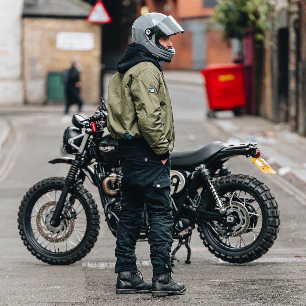 biker wearing black and green motorcycle protective gear
