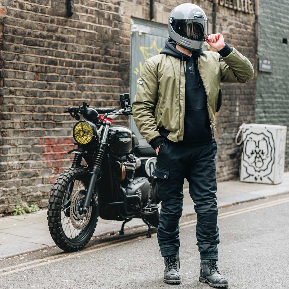 biker wearing grey shoei helmet with olive green bomber jacket for men