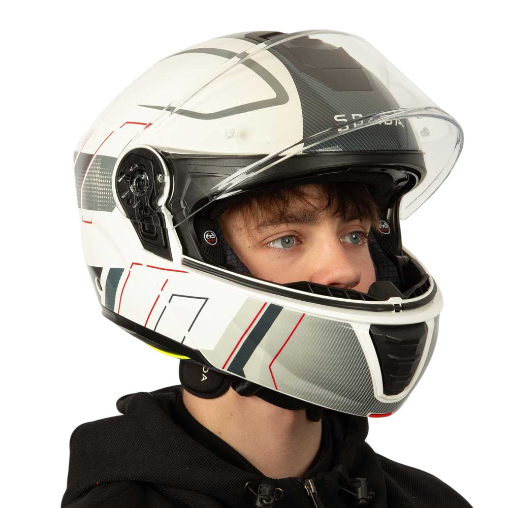 side view of biker wearing black white and grey helmet