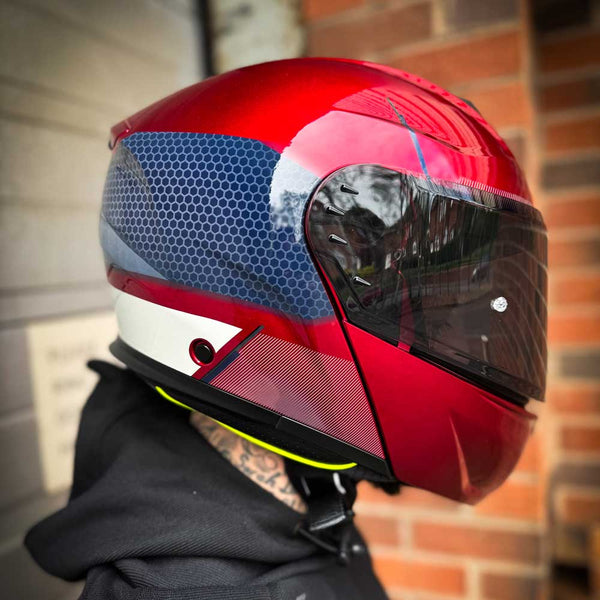 side of biker wearing red motorbike helmet with smoked visor