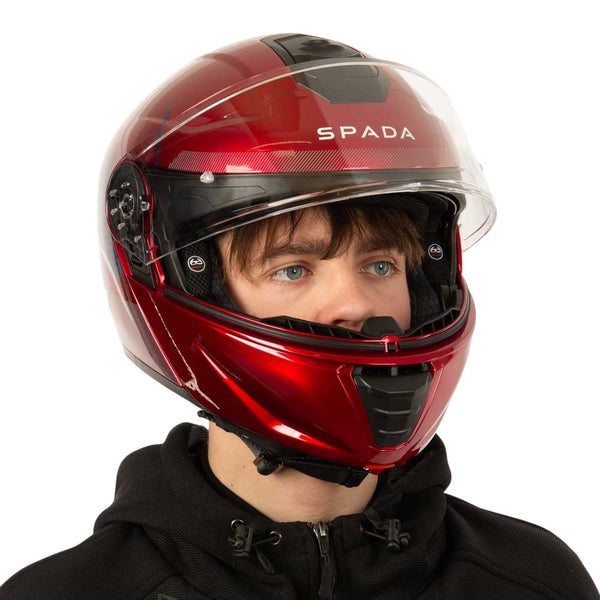side view of biker wearing red motorbike helmet with clear visor