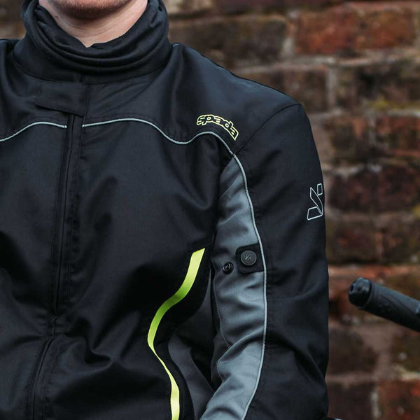 closeup details of black and green fluorescent motorbike jacket