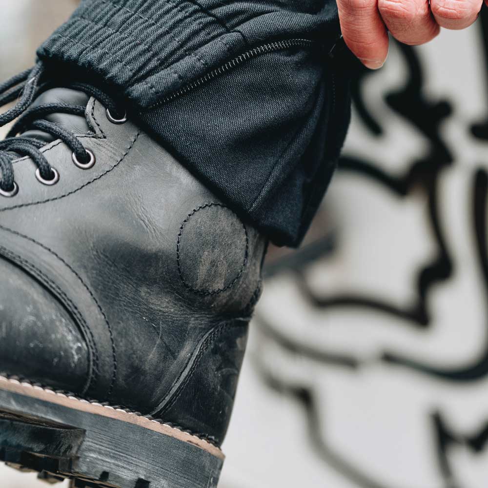 closeup of ankle protector on black motorcycle boots for men