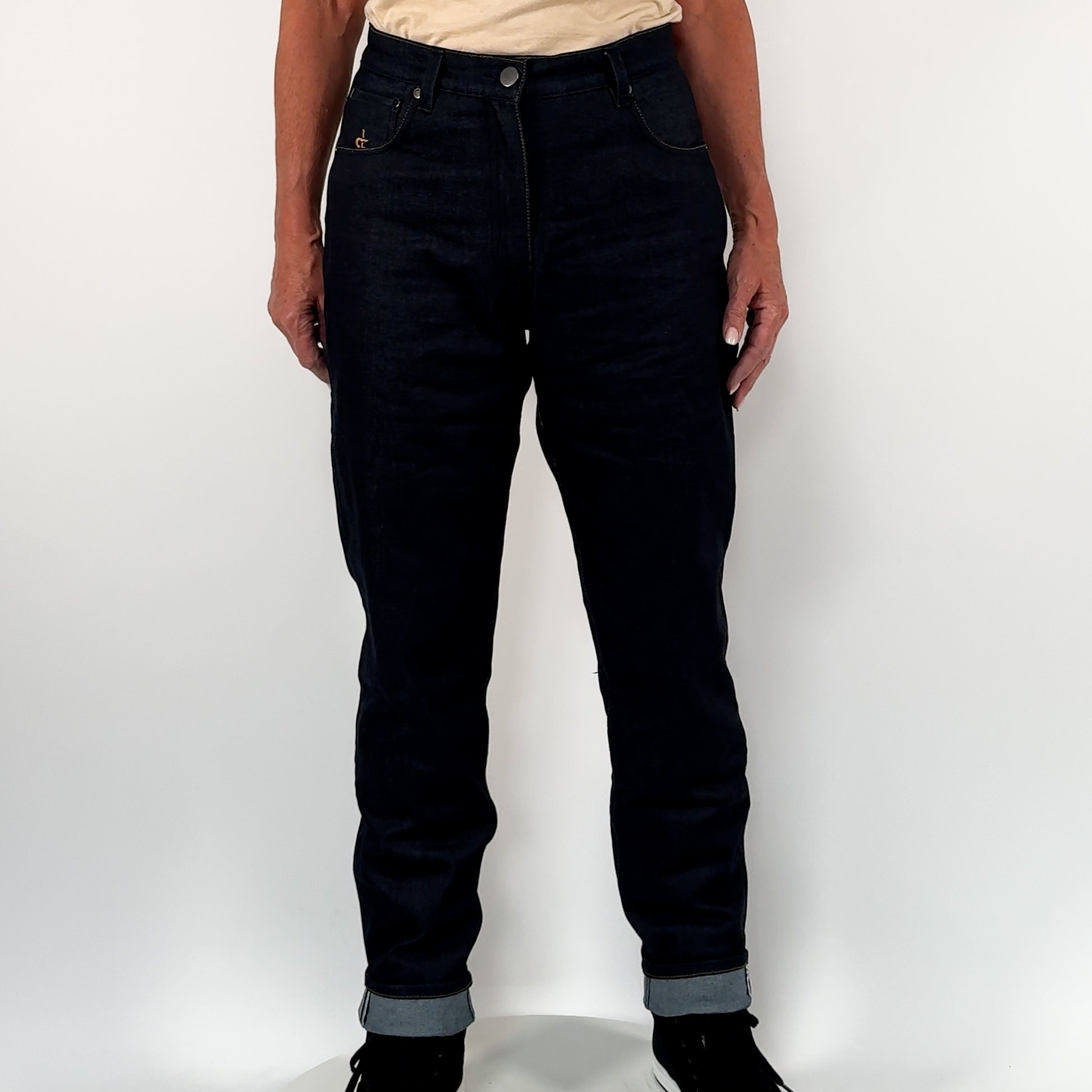 360 spin view of women rider wearing raw denim women's riding jeans