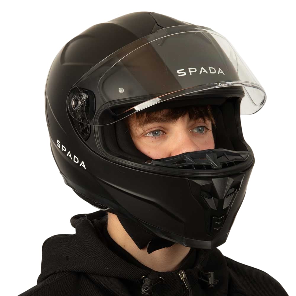 biker wearing matte black motorbike helmet with clear visor