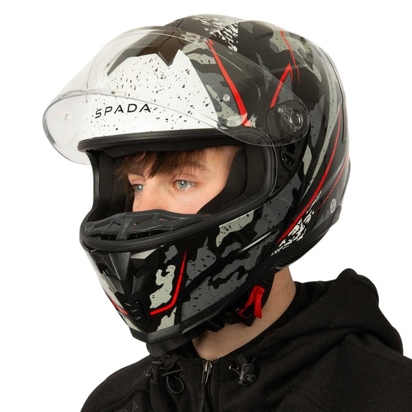 biker wearing black grey and red motorbike helmet with clear visor lifted up