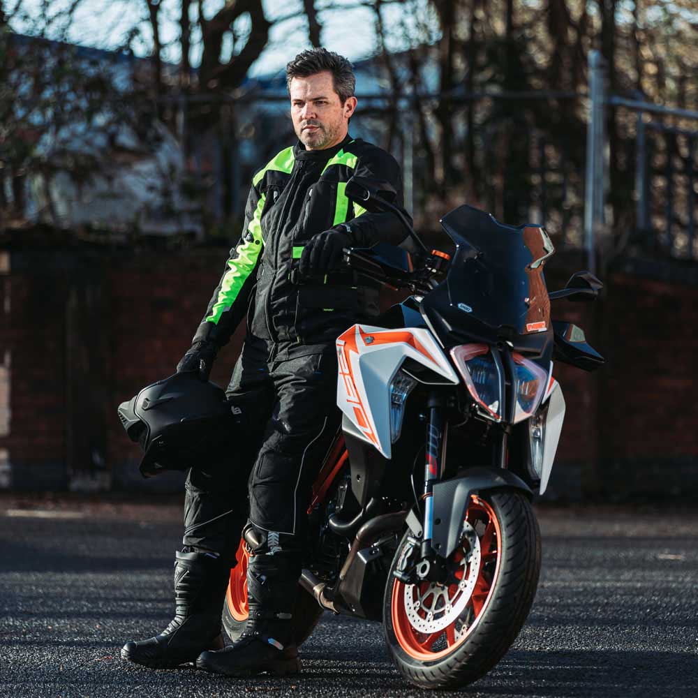 biker wearing motorcycle gear for men on motorbike with black motorcycle boots