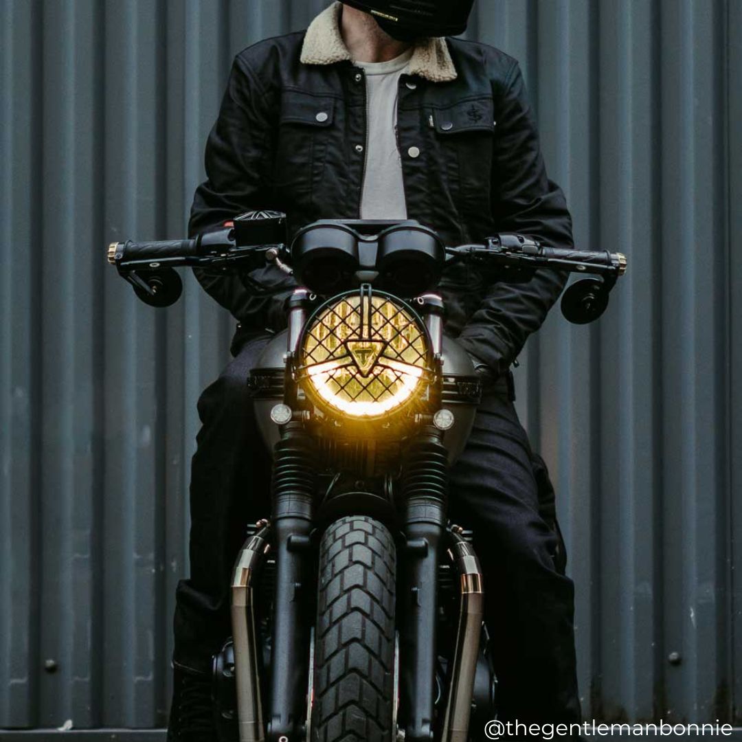 Biker seated on motorcycle wearing men's Trucker Motorcycle Jacket rugged protective denim and Cordura jacket with CE armour.
