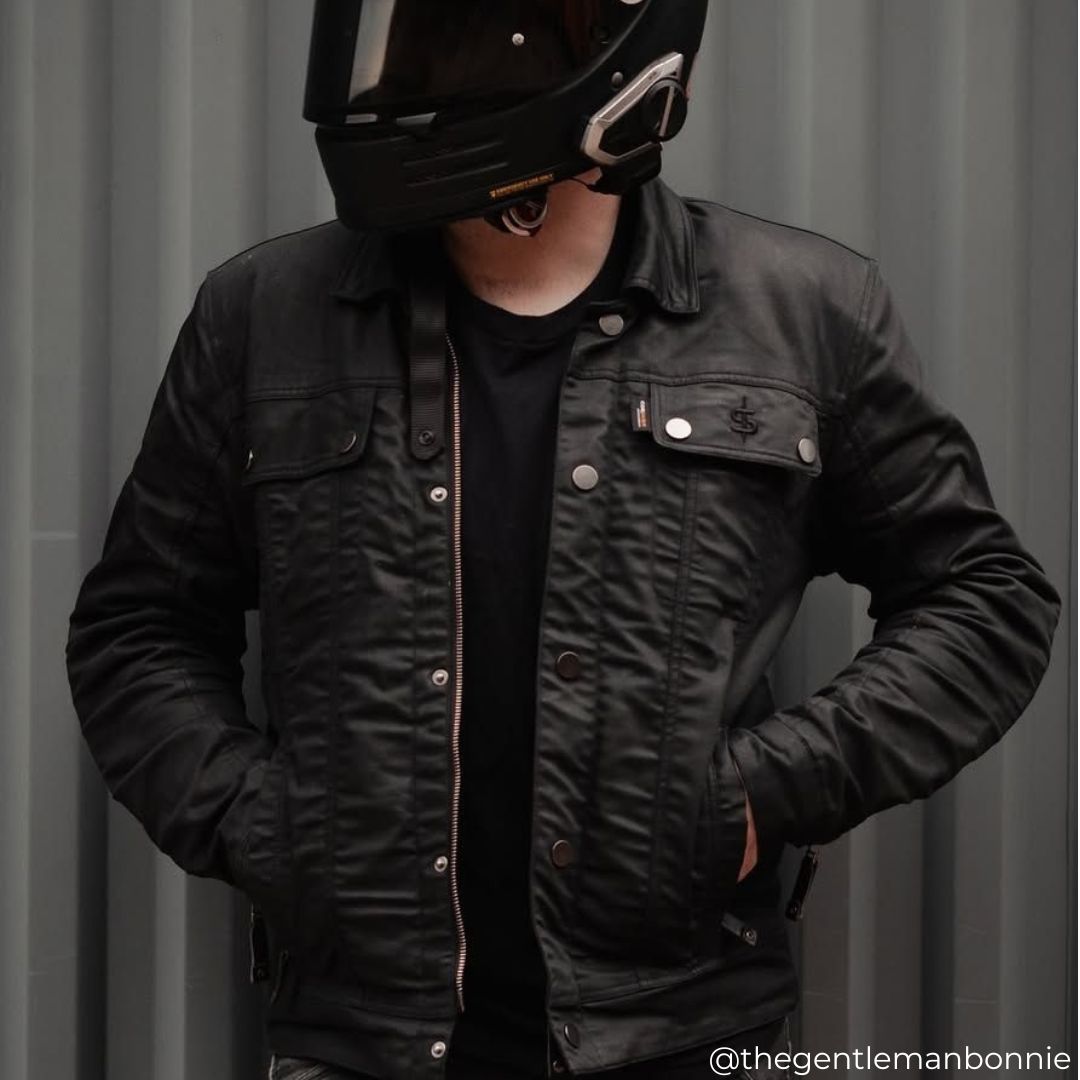 Close-up of biker wearing Temper Black and Tan Trucker Motorcycle Jacket – showcasing Cordura fabric, sherpa collar, and protective details.