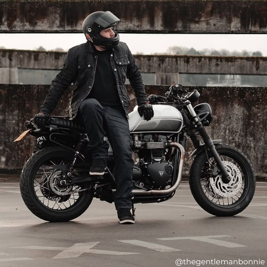 Biker in Temper Trucker Motorcycle Jacket for men leaning on motorcycle – trucker-style riding jacket with sherpa lining and armour.