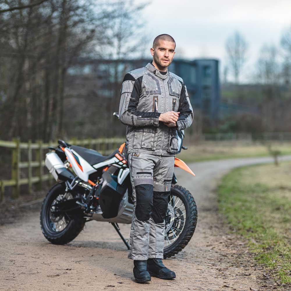 biker wearing black and grey motorbike gear with motorbike