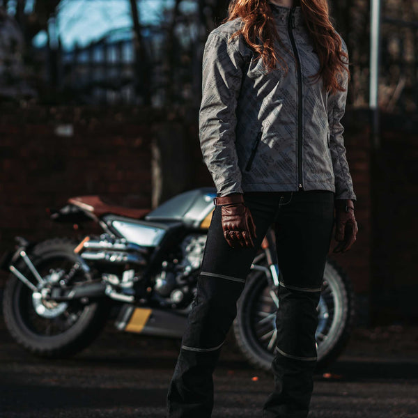 female biker with motorbike wearing ladies motorcycle gear