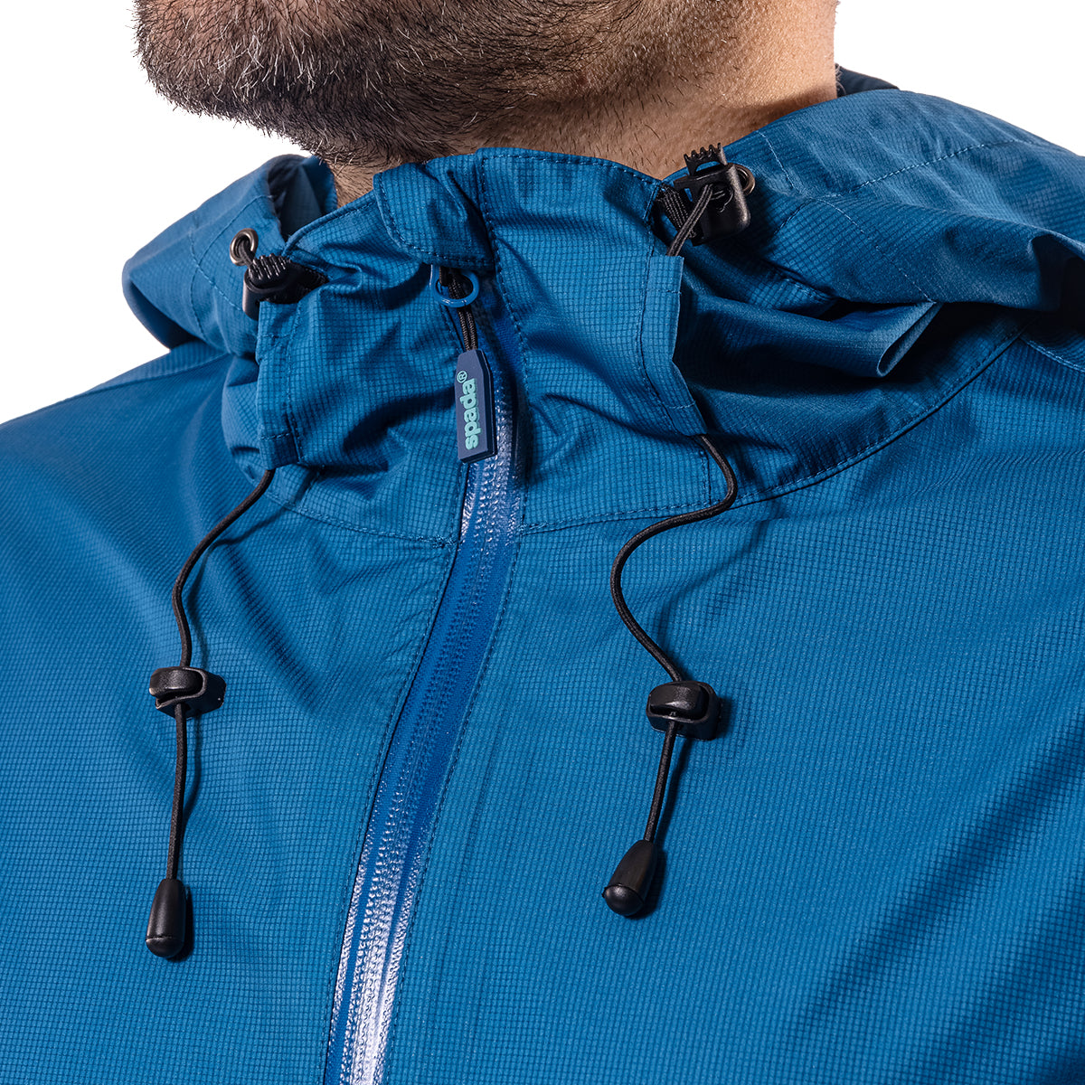 closeup of zipper and adjustable straps on hood of blue jacket for men
